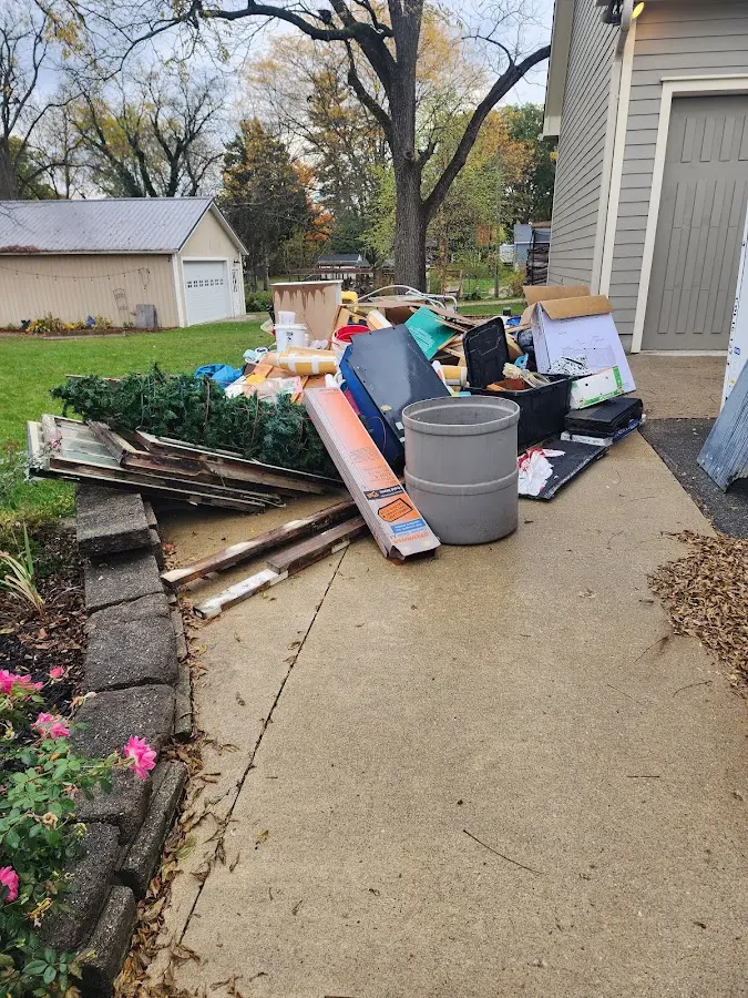 Dumpster being loaded with debris for 12 Yard Dumpster Rental in Lithia Springs